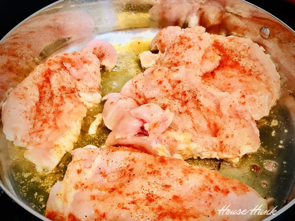 chicken breasts cooking in pan