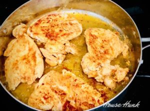 chicken breasts sautéed in a pan