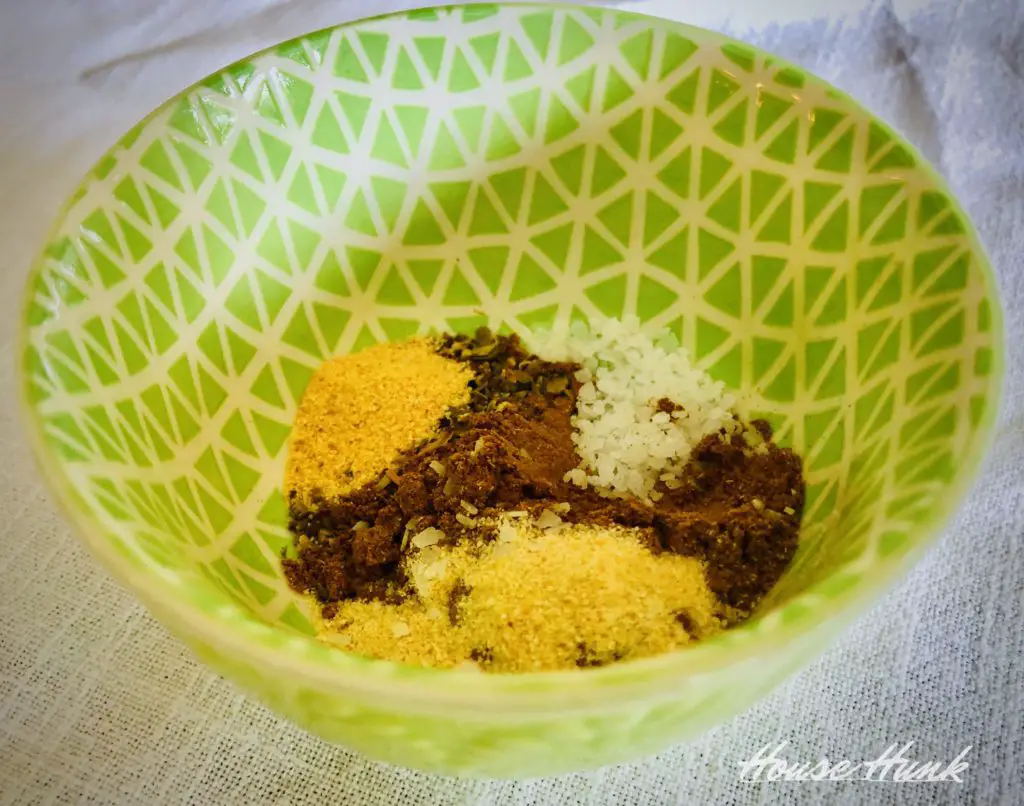 cumin, salt, onion powder, and garlic powder in a green and white bowl