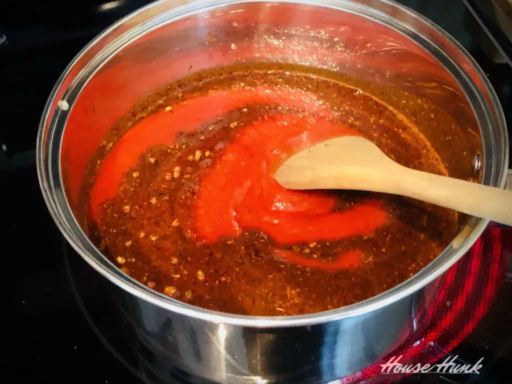 enchilada sauce simmering in a saucepan