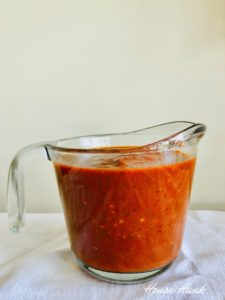 enchilada sauce in a measuring cup