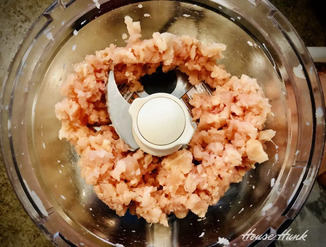 top view of ground chicken in a food processor