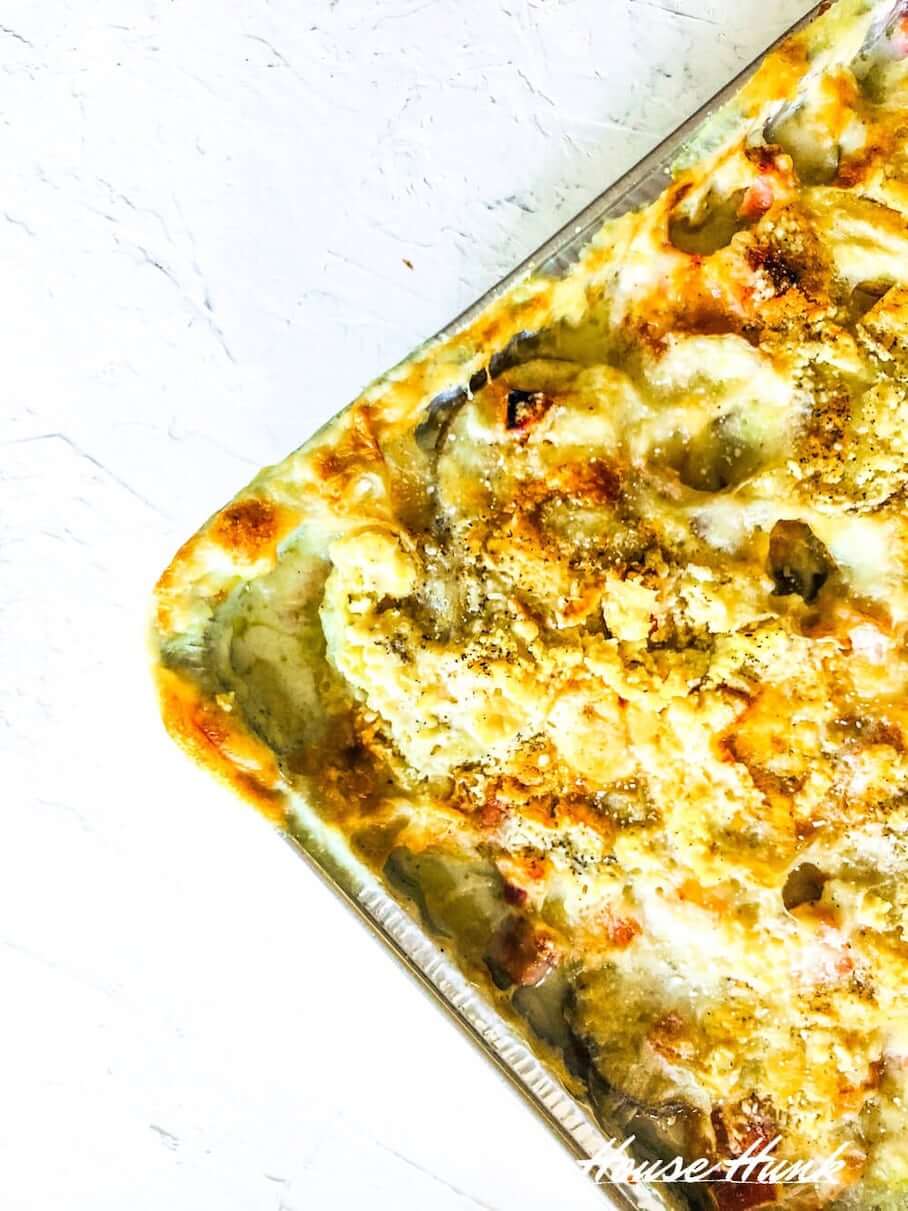The best scalloped and ham potatoes in an aluminum baking tray.