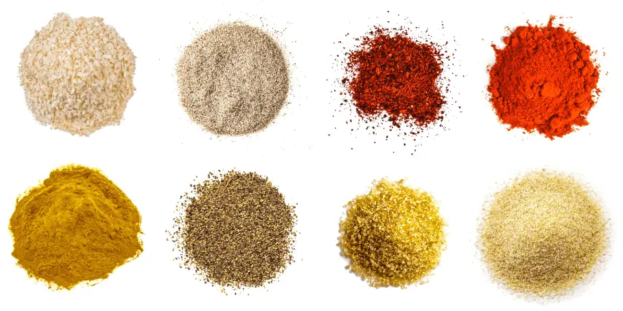 A photorealistic image of ingredients for Homemade Kansas City Style Rib Rub consisting of eight piles of different spices and herbs on a white background.