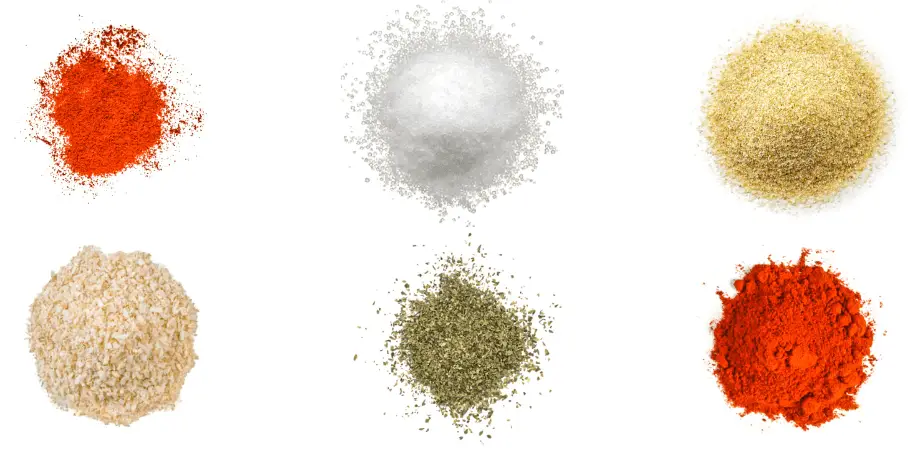 A photorealistic image of ingredients for Homemade Fajita Marinade Seasoning consisting of six piles of different spices and herbs on a white background.