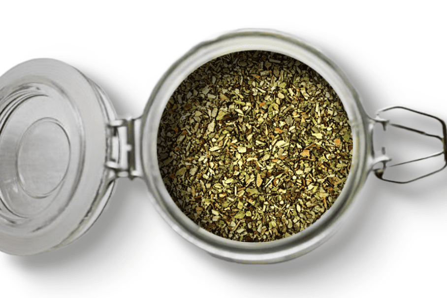 A photo of an open jar of homemade pizza seasoning on a white background.