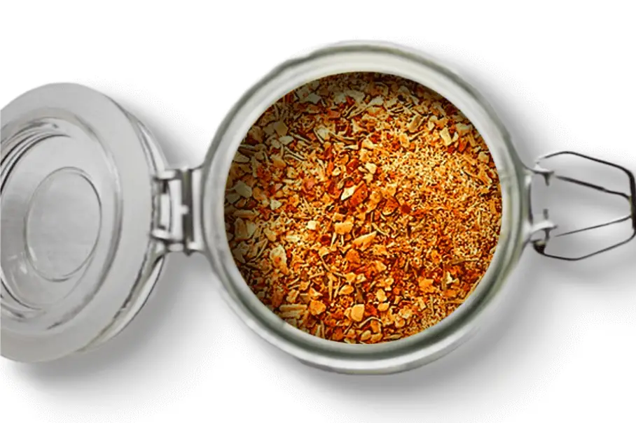 A photo of an open jar of homemade Mediterranean spice blend on a white background.