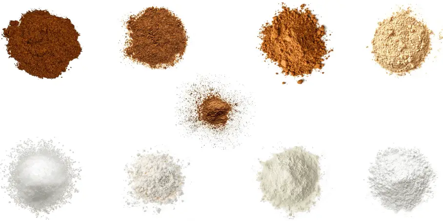 A photorealistic image of ingredients for Homemade Spiced Cocoa Mix consisting of nine piles of different spices and herbs on a white background.