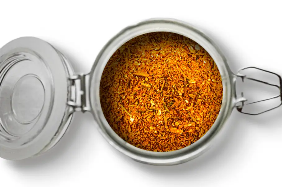 A photo of an open jar of homemade shawarma spice blend on a white background.