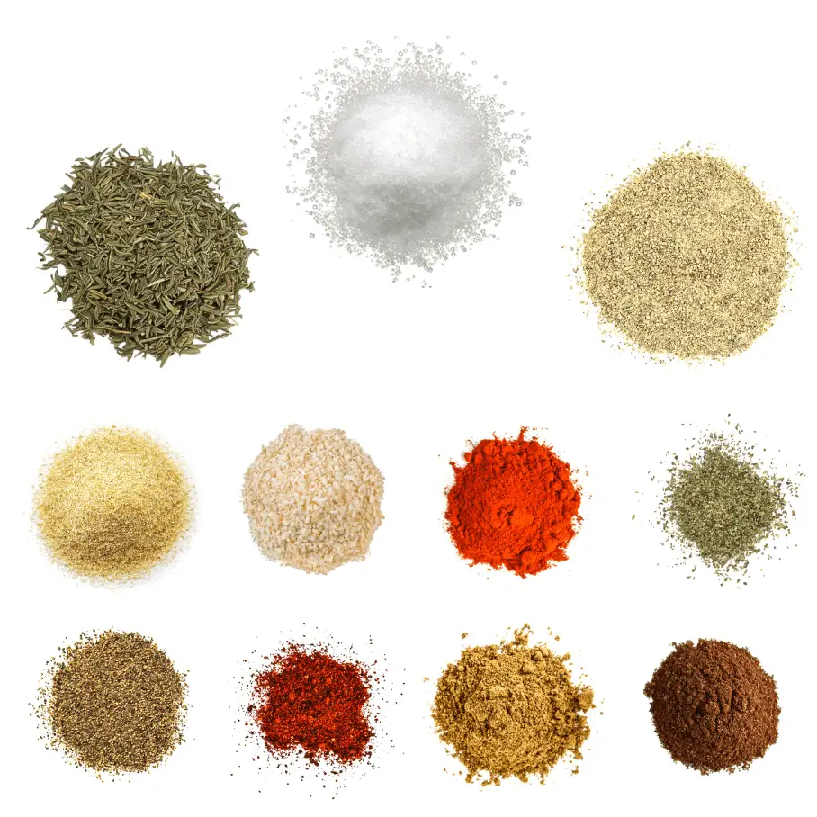 A photorealistic image of ingredients for Homemade Chipotle Creole Spice Rub consisting of eleven piles of different spices and herbs on a white background.