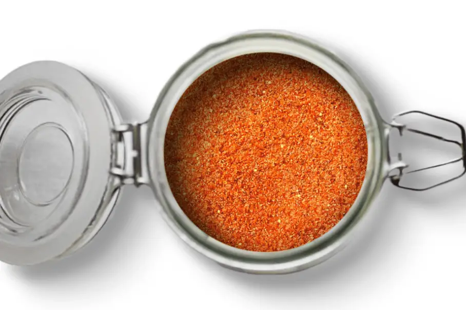 A photo of an open jar of homemade Carolina BBQ rub on a white background.