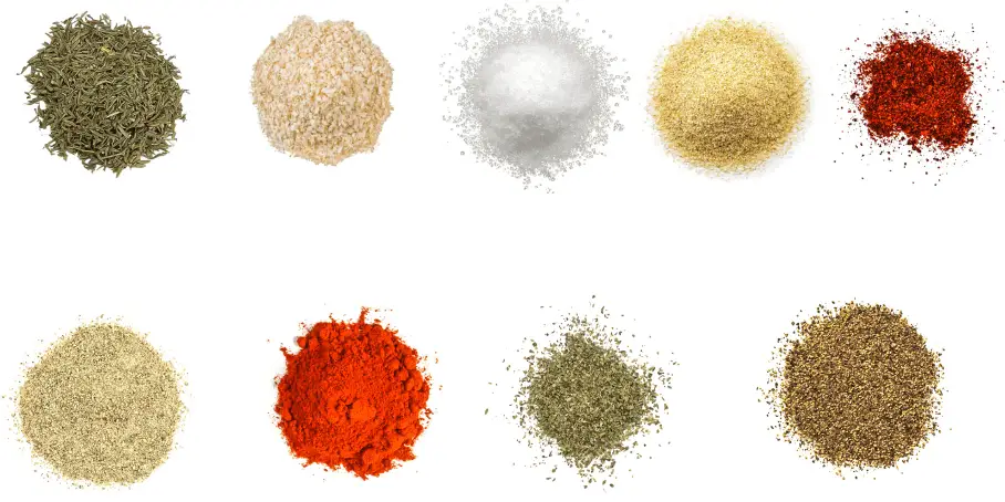 A photorealistic image of ingredients for Homemade Cajun Seasoning consisting of nine piles of different spices and herbs on a white background.