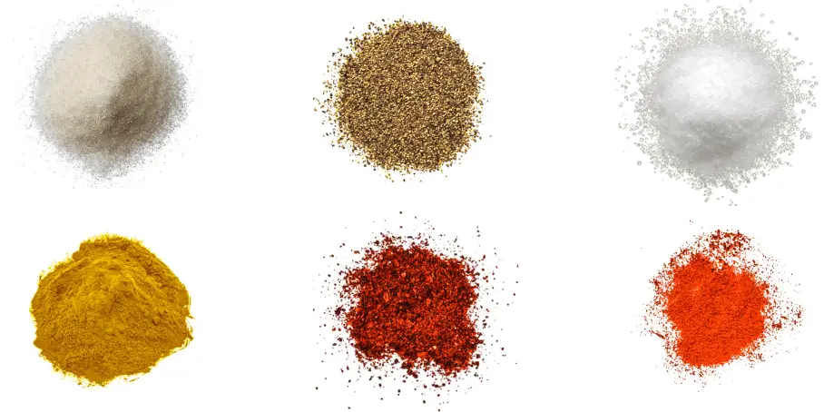 A photorealistic image of ingredients for Homemade Carolina BBQ Rub consisting of six piles of different spices and herbs on a white background.
