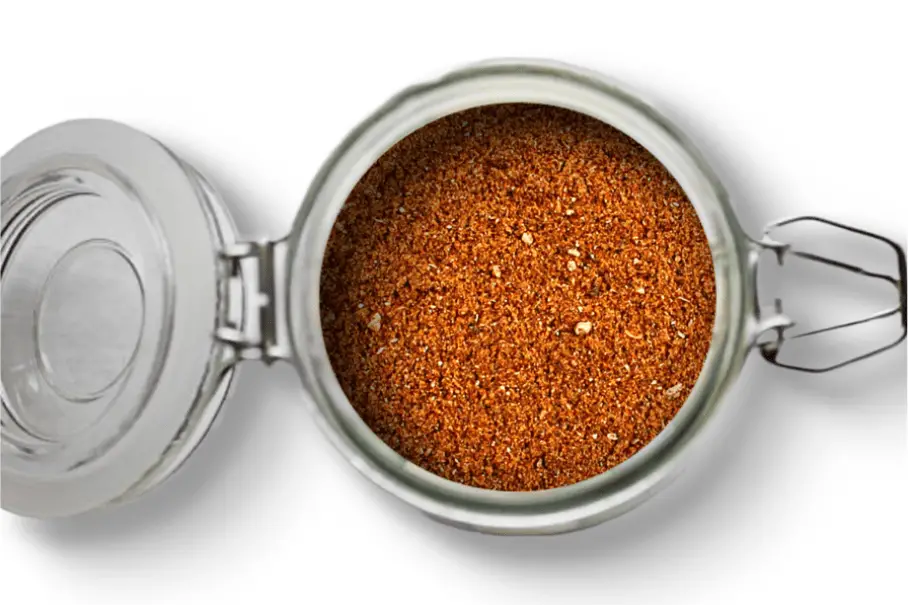 A photo of an open jar of homemade cabs spice mix on a white background.