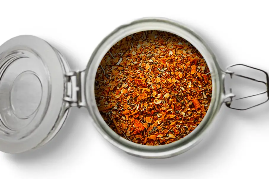 A photo of an open jar of homemade seafood spice blend on a white background.