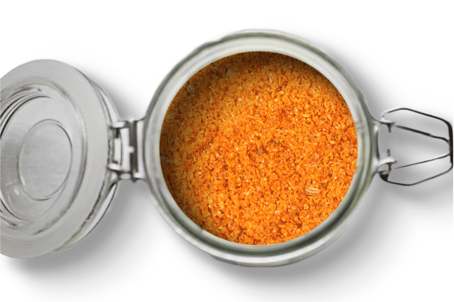 A photo of an open jar of homemade berbere on a white background.