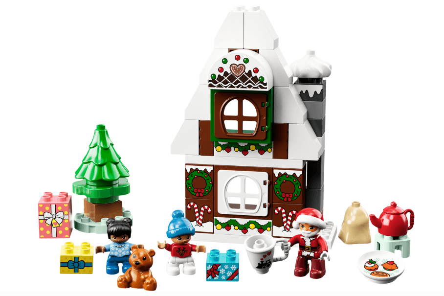 A white background with a Santa's Gingerbread House LEGO set on top.