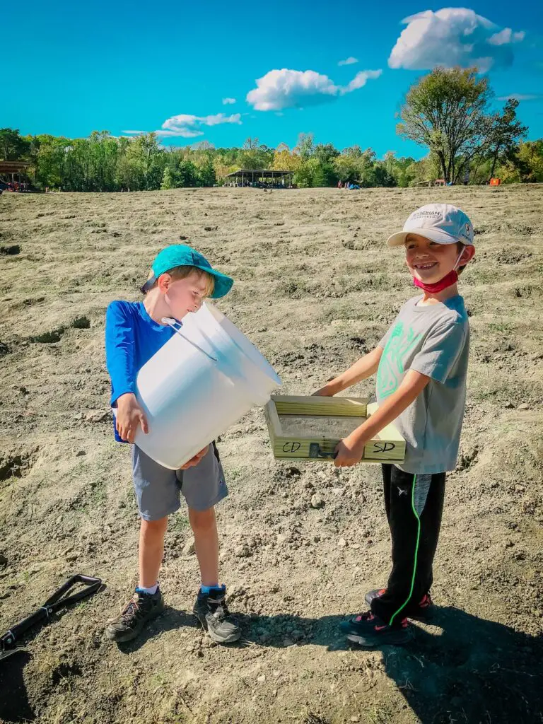 Two children searching for gems in the soil at Crater of Diamonds State Park in Murfreesboro, Arkansas.