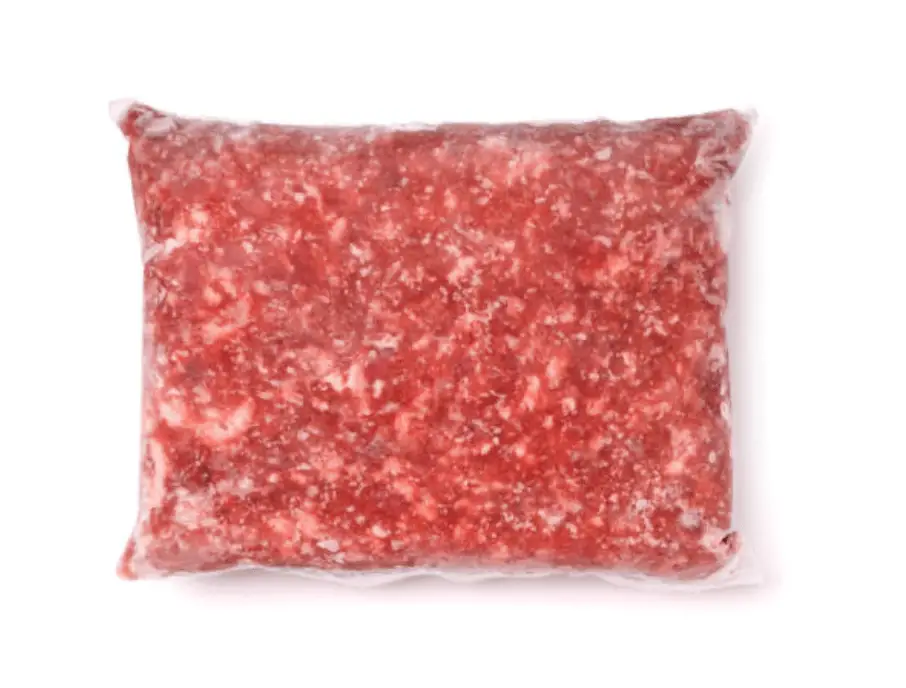 A vacuum sealed package of ground lamb on a white background.