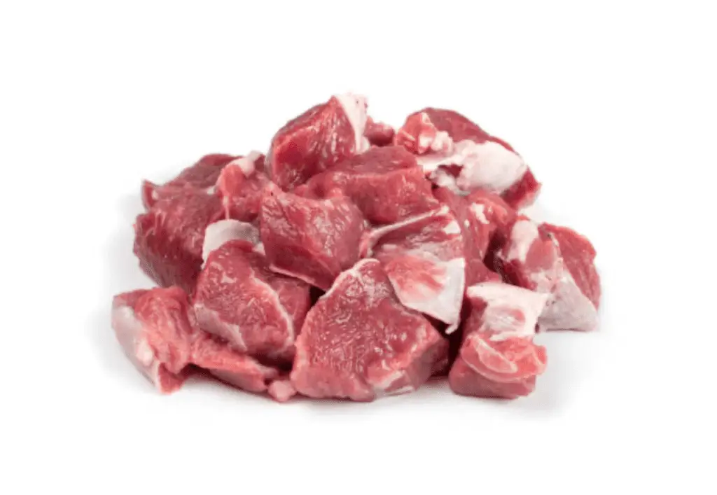 A pile of raw lamb cubes on a white background.