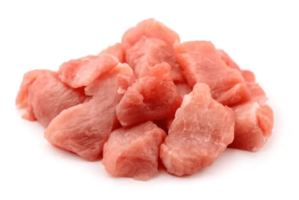 A photo realistic image of raw diced pork tenderloin on a white background.