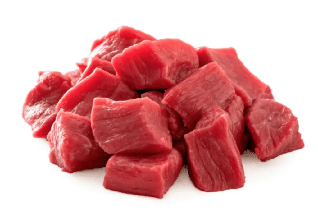 A pile of diced red meat on a white background.