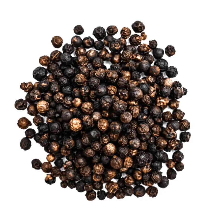 A pile of black peppercorns on a white background, with some blurred areas in the image. The peppercorns are small, round, and black.