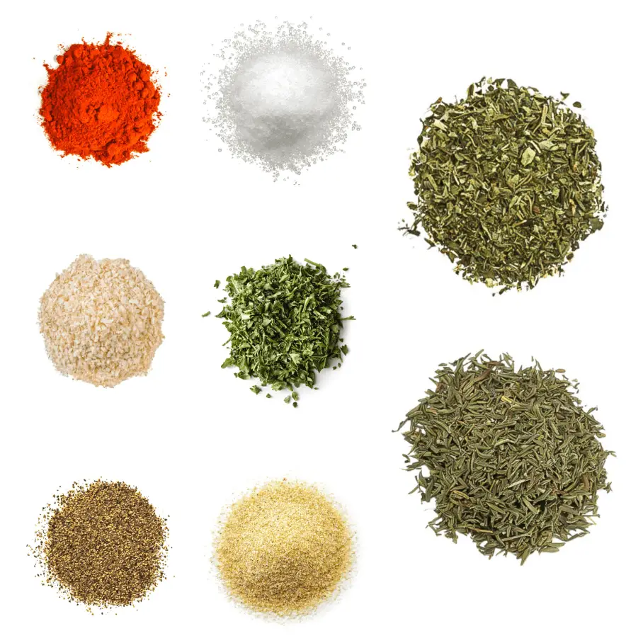 A photorealistic image of ingredients for Homemade Chicken Seasoning consisting of eight piles of different spices and herbs on a white background.