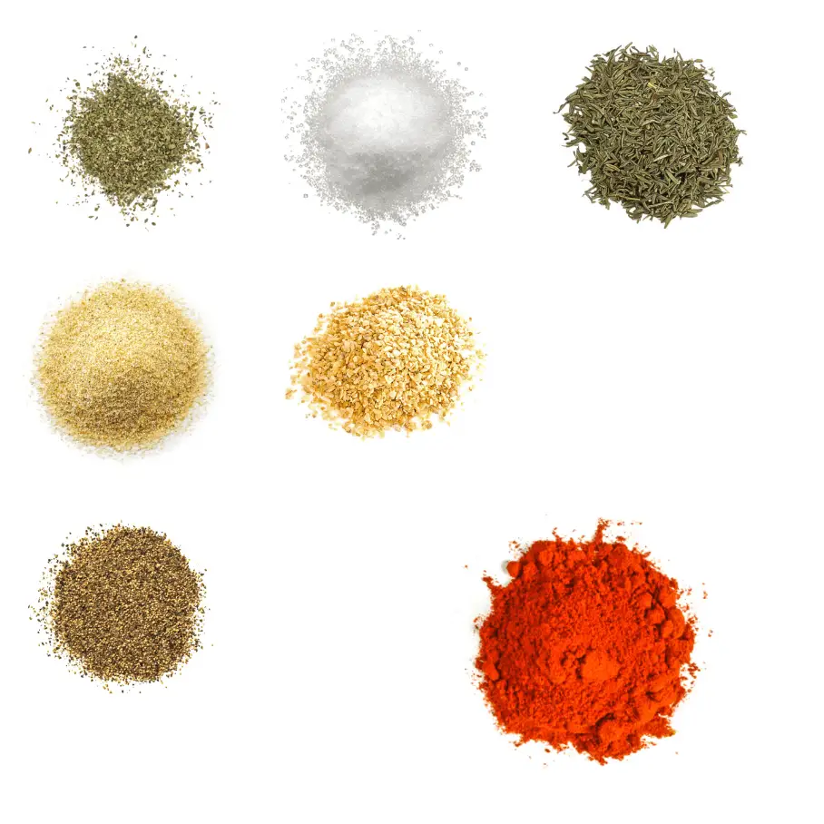 A photorealistic image of ingredients for Homemade Pork Seasoning consisting of seven piles of different spices and herbs on a white background.