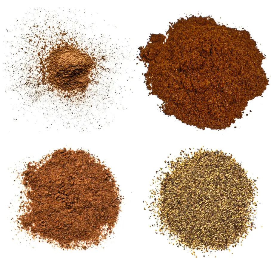 Four piles of different types of ground spices on a white background. The top left pile is light brown and finely ground. The top right pile is dark red-brown and coarsely ground. The bottom left pile is medium red-brown and finely ground. The bottom right pile is light brown with black specks and coarsely ground.