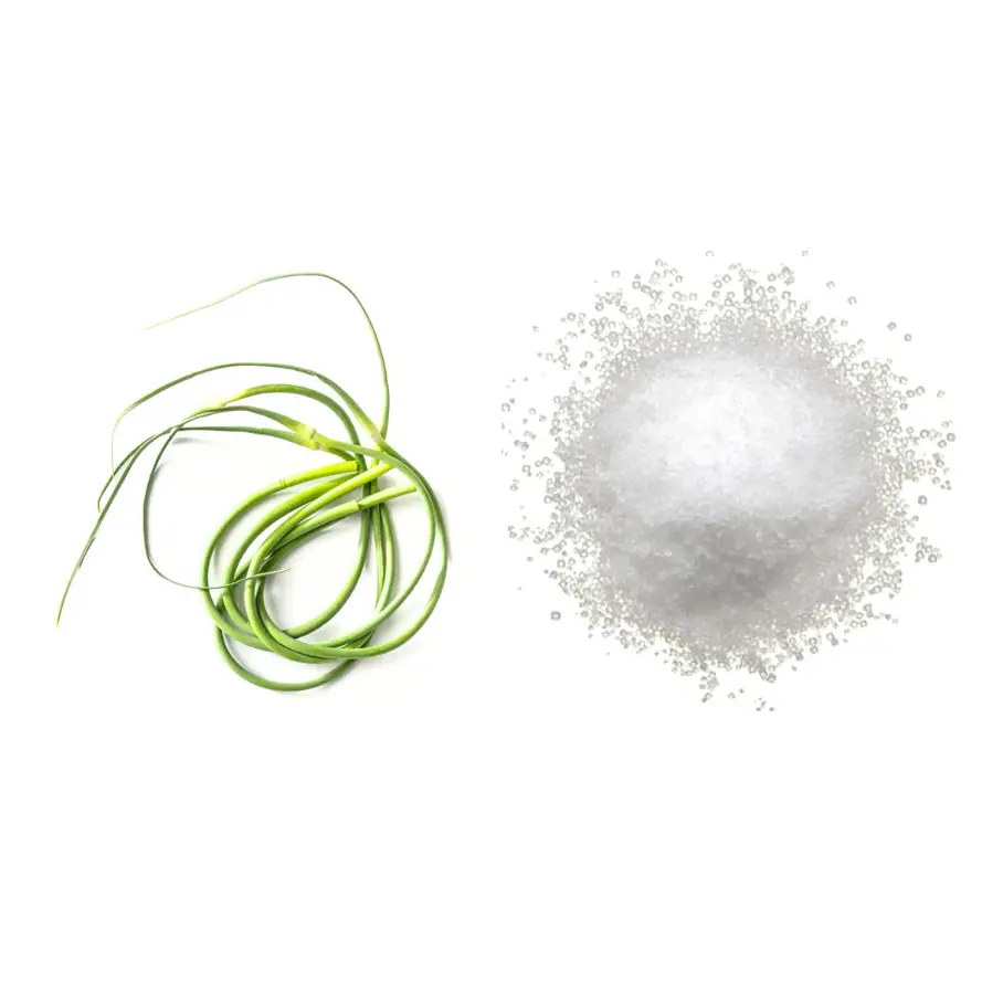 A pile of garlic scapes and a pile of salt on a white background.