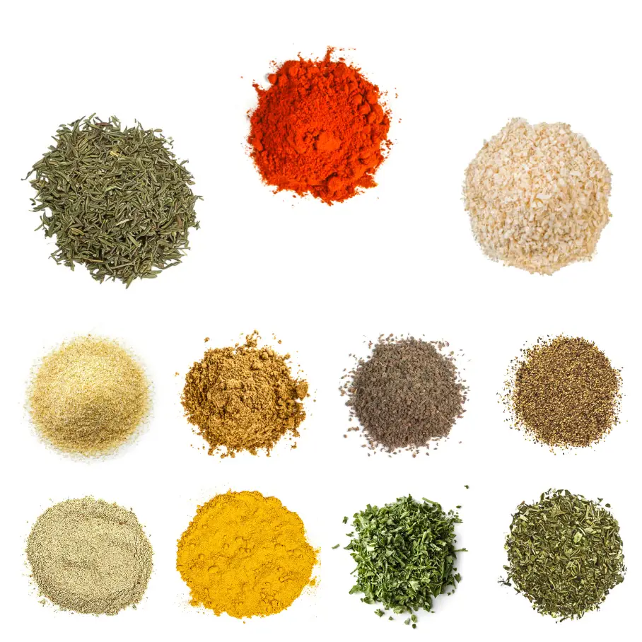 A grid of nine spices and herbs on a white background, including, paprika, garlic powder, cumin, black pepper, and onion powder.