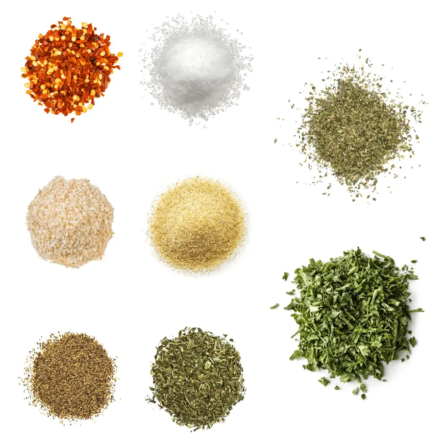 A photorealistic image of ingredients for Homemade Artichoke Seasoning consisting of eight piles of different spices and herbs on a white background.