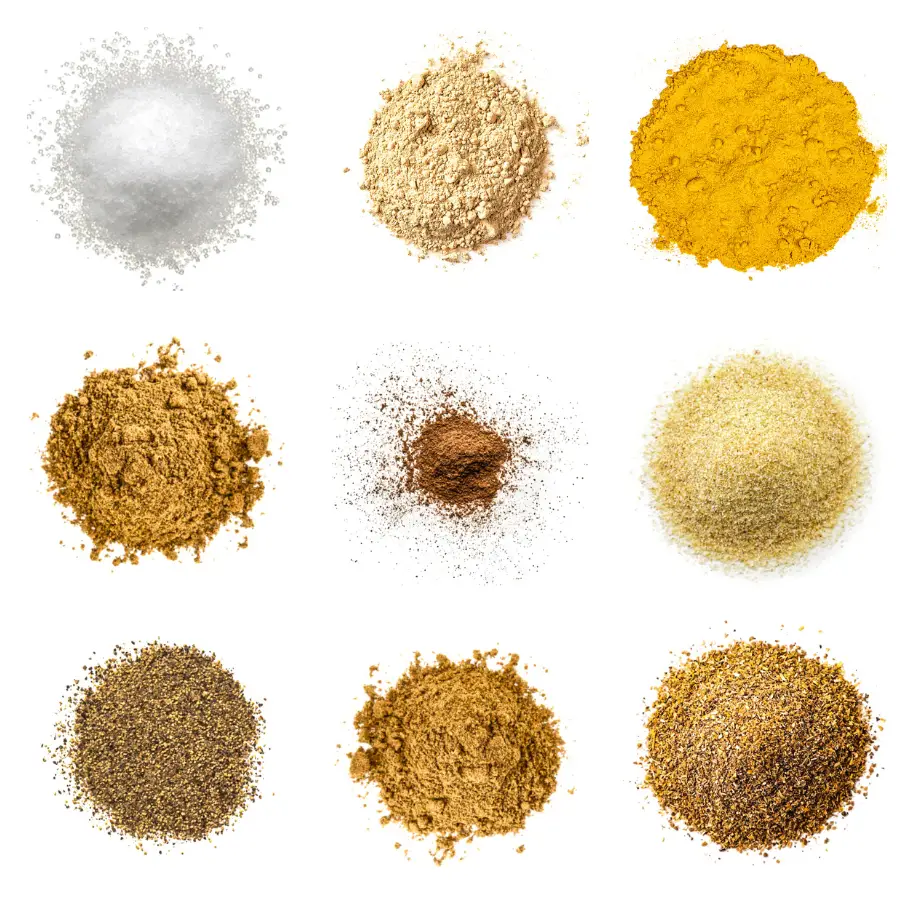 A photorealistic image of ingredients for Homemade Cumin-Coriander Seasoning consisting of nine piles of different spices and herbs on a white background.