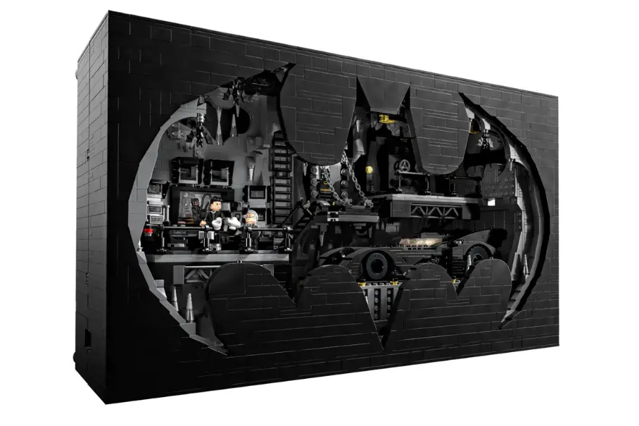 A photo realistic image of a Lego set of the Batcave from the Batman series. The set is predominantly black in color with some grey and yellow accents. The set is built in a diorama style with a large bat symbol in the background. The set features a batmobile, a batwing, a batcycle and a batboat. The set also features a control center, a laboratory, a computer and a jail cell. The set includes minifigures of Batman, Robin, Alfred and the Joker. The set is displayed on a white background.