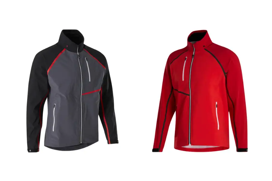 A photo realistic image of two jackets side by side. The jacket on the left is a dark grey color with red accents on the collar, zipper, and pockets. The jacket on the right is a bright red color with white accents on the collar, zipper, and pockets. Both jackets have a full zipper and two pockets on the front. The jackets appear to be made of a synthetic material and have a high collar. The background is white.