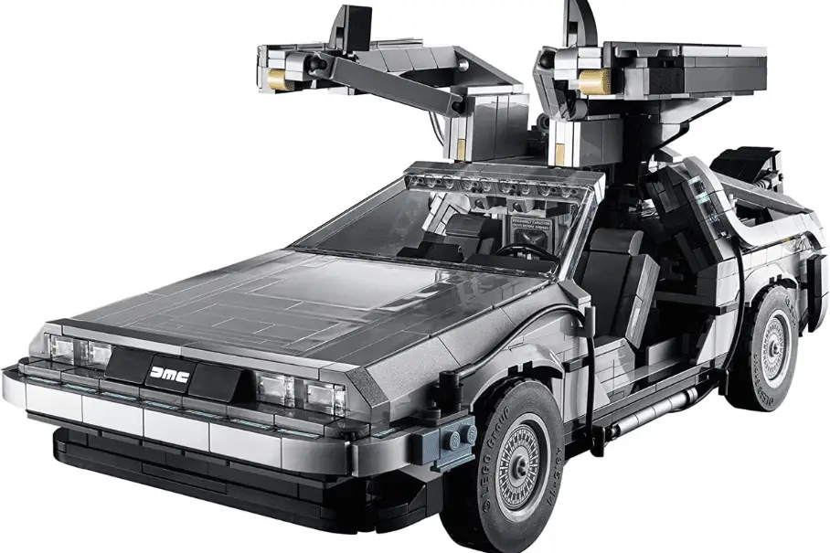 A Lego model of the DeLorean car from the movie “Back to the Future” is shown on a white background. The car is silver with black accents and has gull-wing doors and a flux capacitor. The car is made of Lego bricks and has a detailed interior.