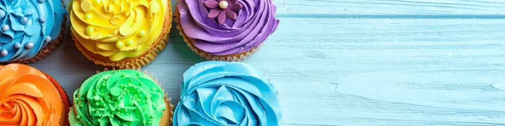a row of cupcakes with colorful frosting